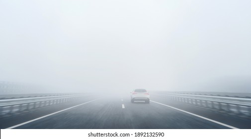 a car on the freeway in the heavy fog - Powered by Shutterstock