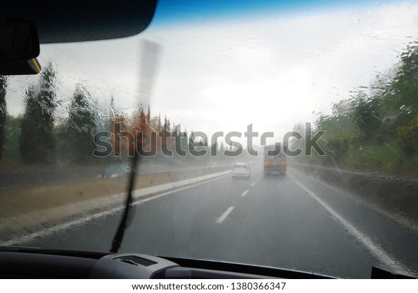 Car on a
highway with heavy rain and bad
weather