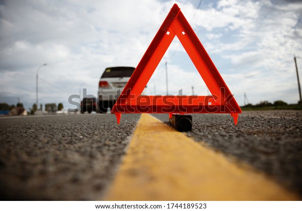 car on the highway\
and warning triangle