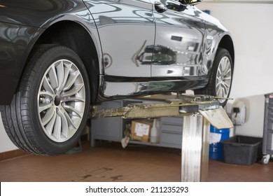 Car On Hoist At Repair Shop