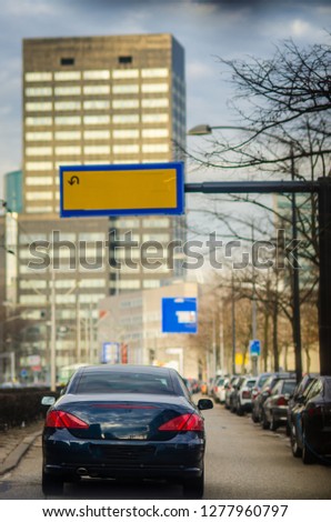 Car on the Holland Street and Empty Traffic Sign