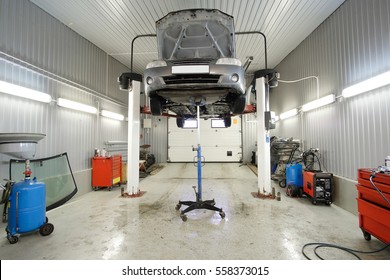 Car On A Lift In A Car Repair Station