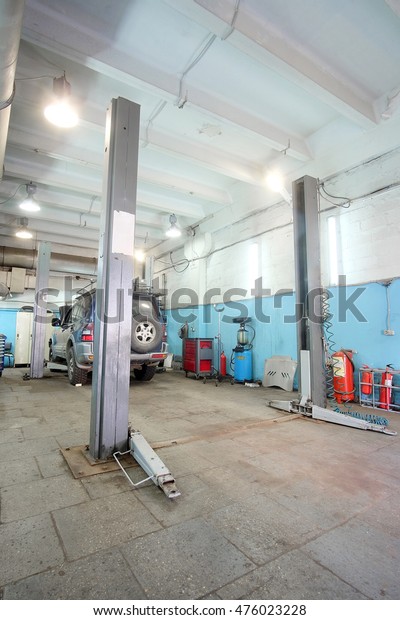 Car\
on a lift in a car repair station in Moscow,\
Russia