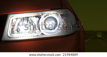 Car on the road. Close-up of the headlight.