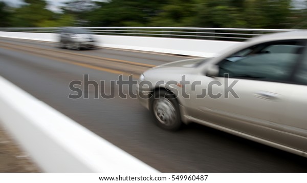 The car is on\
the road fast and blurred\
images.