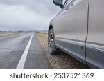 The car on the road in the steppe , auto touring and the concept of travelling.