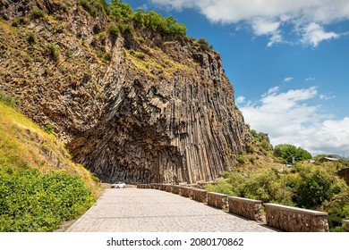Car on a road way to an important natural attraction of Armenia - a Symphony of Stones or basalt Pillars