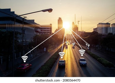 Car On Road With Wifi Signal Data Link Icon In Concept Of Smart City Connect With Sunrise Town And Building Background Landscape