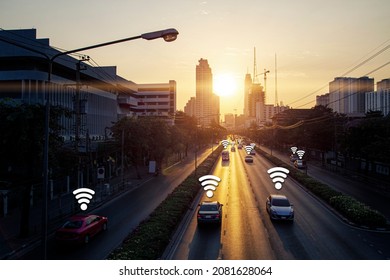 Car On Road With Wifi Signal Data Link Icon In Concept Of Smart City Connect With Sunrise Town And Building Background Landscape