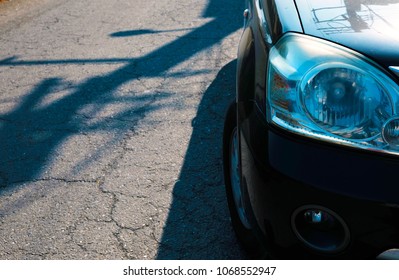 The Car On The Roadside And The Shadow Of Telephone Pole.