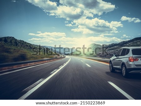 Car on a scenic road. Car on the road surrounded by a magnificent natural landscape.