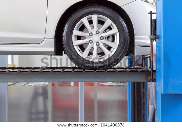 car on service\
garage with mechanical tools for car under repair, auto mechanic\
working in car service\
centre