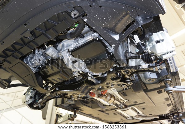 Car on service,\
lifted on a lift. View of the engine and gearbox from below.       \
                       