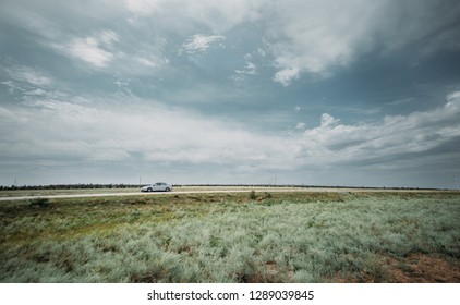 the car is on the side of the fields