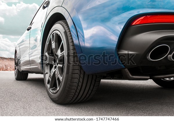Car on sky\
background. Car wheels close up on a background of asphalt. Car\
tires. Car wheel close-up. for\
advertising