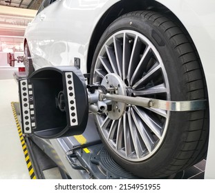 A Car On A Stand With Sensors On The Rear Wheels. For Camber And Toe In Angle Adjustment Wheel Alignment Check In The Workshop Of The Service Station.