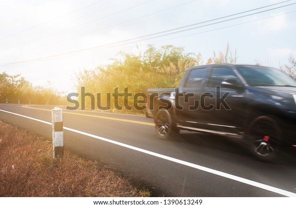 Car on street in the countryside with the\
traveling at sunlight.