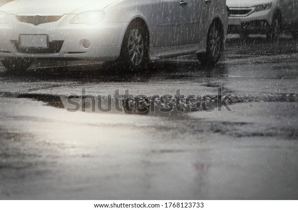 Car on the wet street after hard rain\
fall,selective focus.