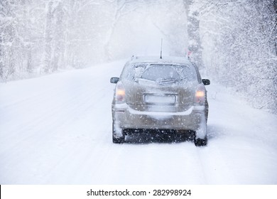 Car On The Winter Road In Snowstorm Time