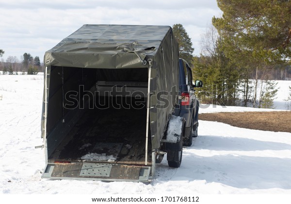 Car open\
trailer with awning. A car with a\
trailer.