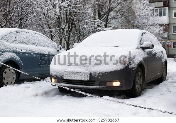 car outdoor\
in a winter morning with snow\
covered