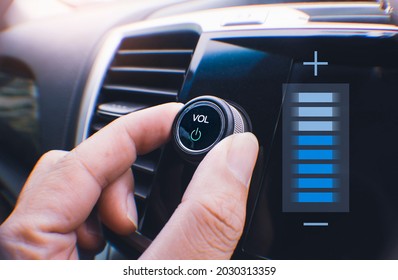 Car Owner Hand Turning Volume Button Of A Car Audio System In The Car