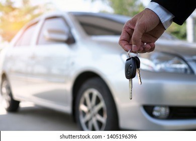 The Car Owner Is Standing The Car Keys To The Buyer. Used Car Sales  