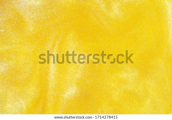 Car paint close-up. Yellow paint background
with abstract patterns.