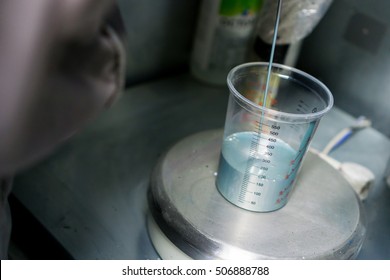 Car Paint Mixing In Recipient On A Balance Scale, Pouring Paint