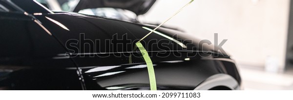 Car paint polishing with machine and removing\
protection tape