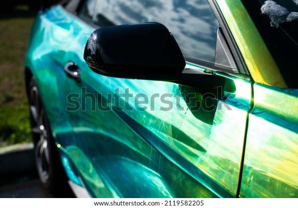 The car is painted in chameleon paint with a\
greenish-yellow tint.