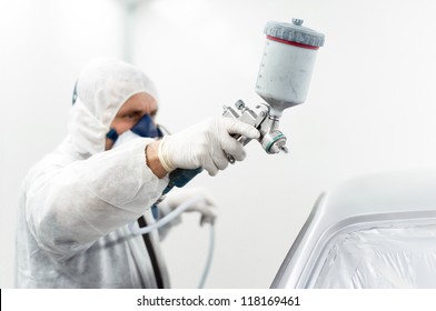 Car Painter Working On A Car In A Special Painting Booth