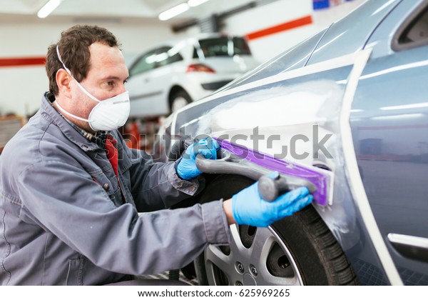 Car painting procedure at auto service store.\
Selective focus.