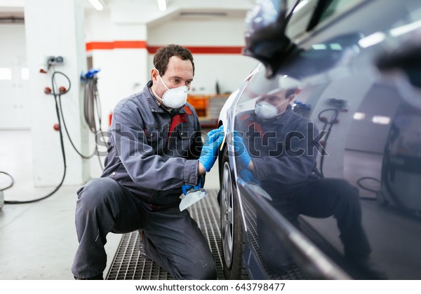 Car painting procedure at auto service store. Selective\
focus. 