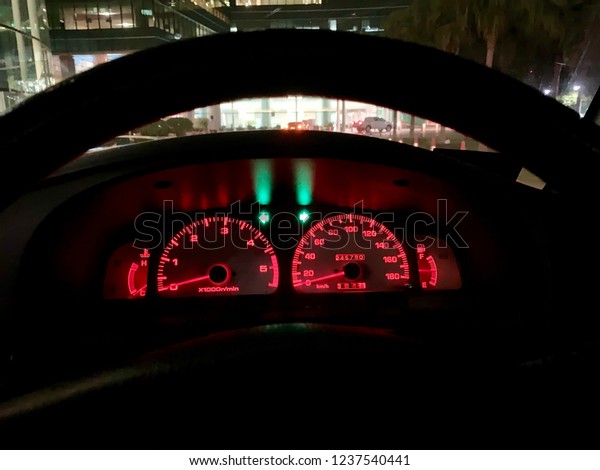 Car panel control with hazard lights sign in the\
dark night