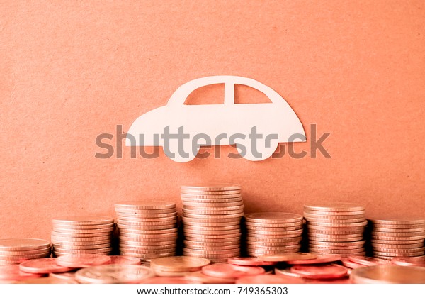 car paper model and row of coin for finance about car\
concept 
