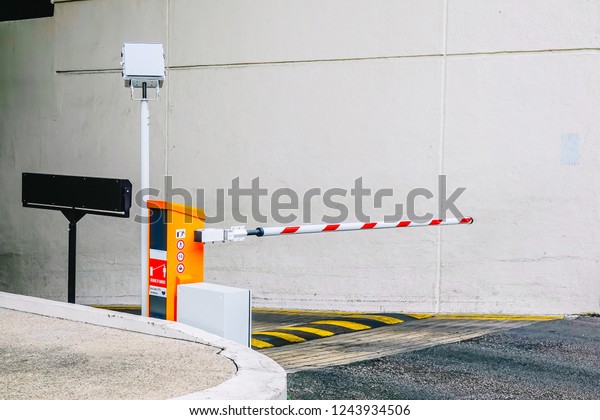 Car park barrier,\
Security system for building access - barrier gate stop with\
traffic cones and cctv