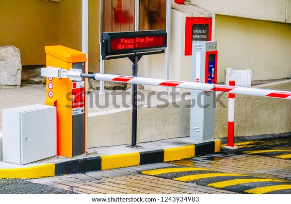 Car park barrier,\
Security system for building access - barrier gate stop with\
traffic cones and cctv
