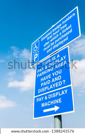 Car park sign warning disabled drivers that payment is required after 1 hour
