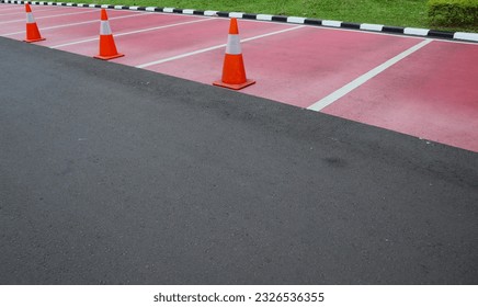 Car park in wide yard. Empty space in a parking lot or outdoor car park marked with red and white paint
