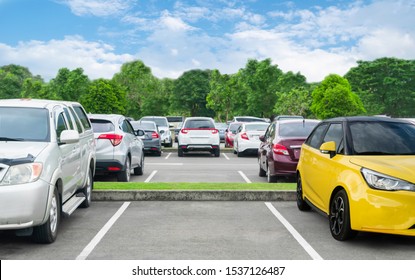 Car Parked In Asphalt Parking Lot And Empty Space Parking  In Nature With Trees And Mountain Background .Outdoor Parking Lot With Fresh Ozone And Eco Friendly Green Environment Concept
