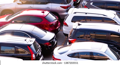 Car parked at concrete parking lot of shopping mall in holiday. Aerial view of car parking area of the mall. Automotive industry. Automobile parking space. Global automobile market concept.