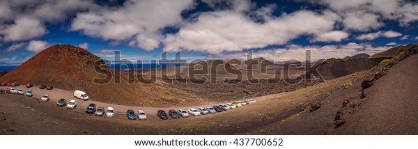 Car parked at the entrance to the Timanfaya\
National Park ( also called The Montanas del Fuego or Mountains of\
Fire ) in Lanzarote, Canary Islands. Picture taken in April 2016 in\
Fuerteventura, Spain