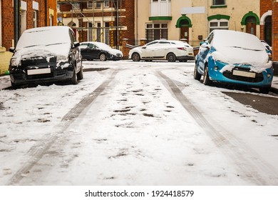 Car Parked On British Street Under Winter Snow Fall In England Uk.