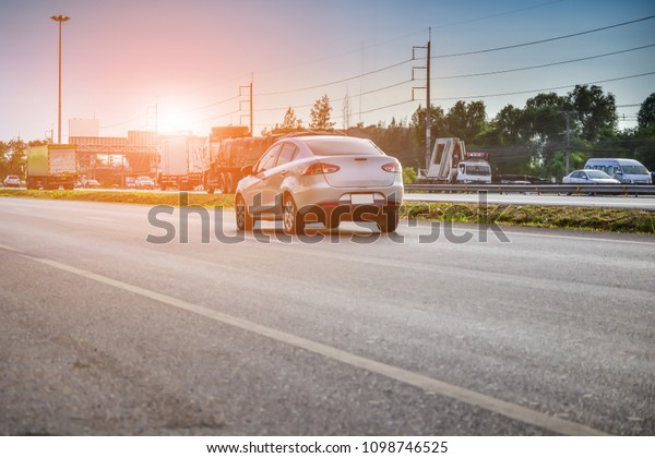 Car parked on road,Car on street and driving on\
highway road