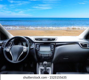 Car Parked On The Shore Of The Beach In Summer