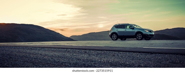 Car parked on side of the road in high mountains panorama - Shutterstock ID 2273515911