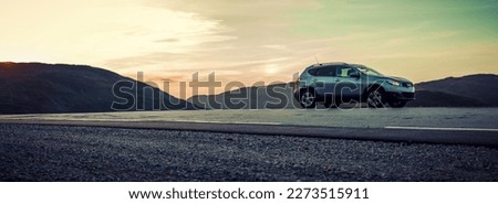 Car parked on side of the road in high mountains panorama