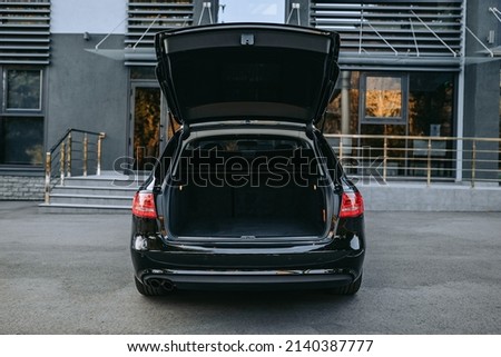 The car is parked with an open trunk. Rear view