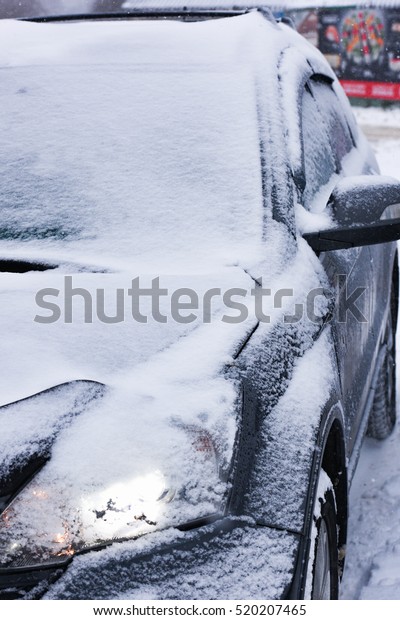 car is parked tunes with a thick layer of snow\
blizzard cold winter